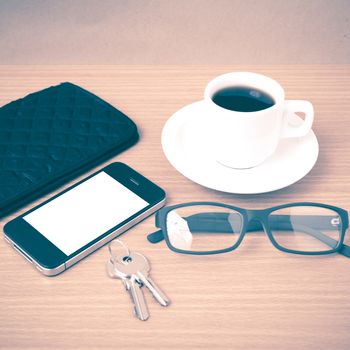 coffee,phone,key,eyeglasses and wallet on wood table background vintage style