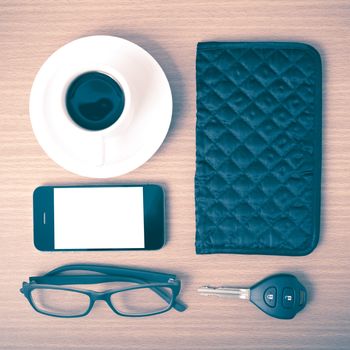 coffee,phone,car key,eyeglasses and wallet on wood table background vintage style