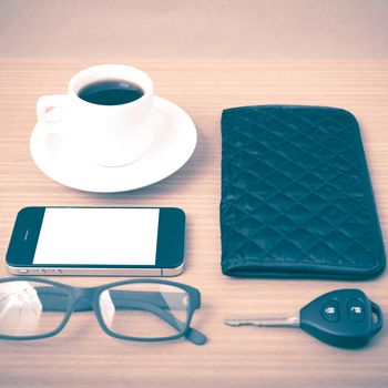 coffee,phone,car key,eyeglasses and wallet on wood table background vintage style