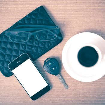 coffee,phone,car key,eyeglasses and wallet on wood table background vintage style