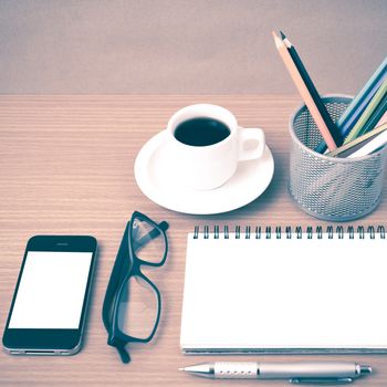 coffee,phone,eyeglasses,notepad and color pencil on wood table background vintage style