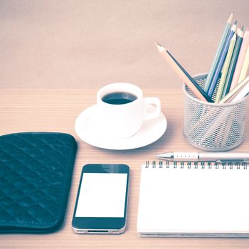 coffee,phone,eyeglasses,notepad,wallet and color pencil on wood table background vintage style