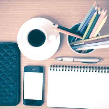 coffee,phone,eyeglasses,notepad,wallet and color pencil on wood table background vintage style
