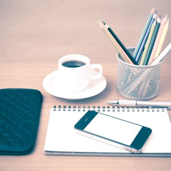 coffee,phone,eyeglasses,notepad,wallet and color pencil on wood table background vintage style