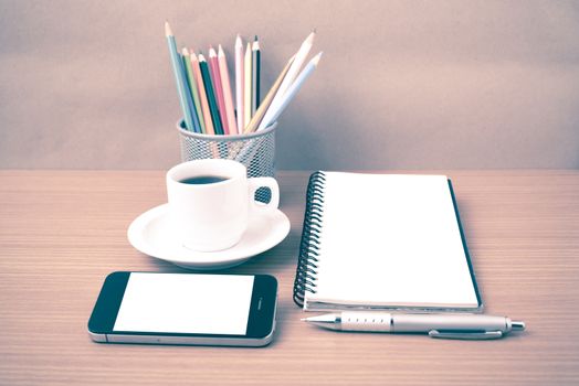 coffe,phone,notepad and color pencil on wood table background vintage style