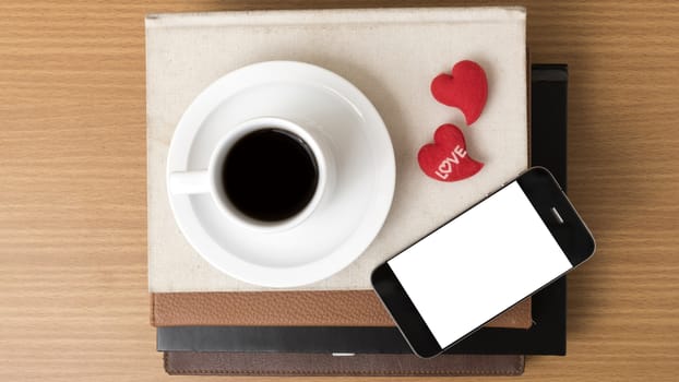 coffee,phone,stack of book and heart on wood table background