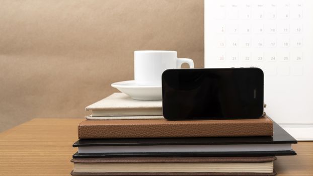 coffee,phone,stack of book and calendar on wood table background