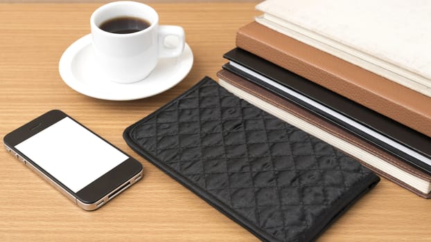 coffee,phone,stack of book and wallet on wood table background