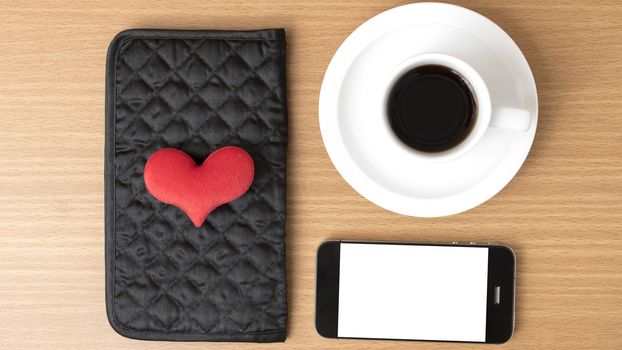 coffee,phone,wallet and heart on wood table background