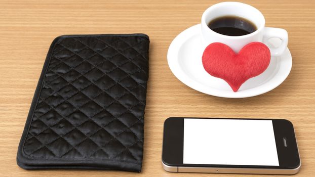 coffee,phone,wallet and heart on wood table background