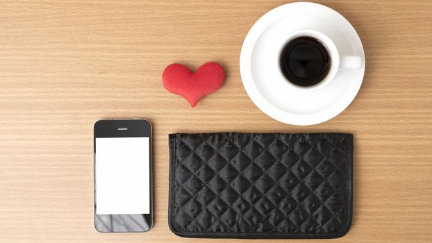 coffee,phone,wallet and heart on wood table background