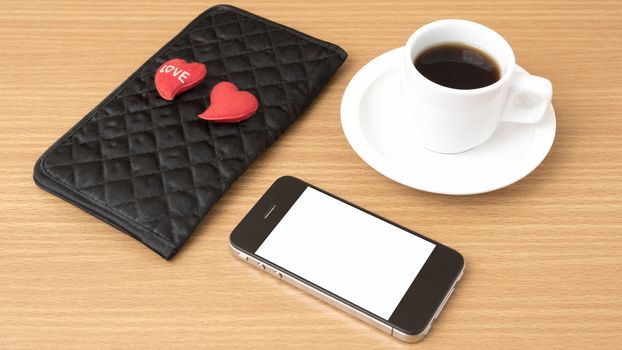 coffee,phone,wallet and heart on wood table background