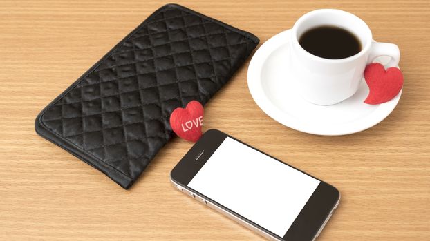 coffee,phone,wallet and heart on wood table background
