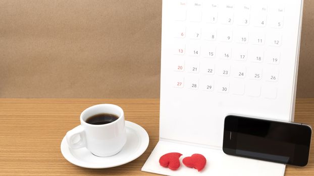 coffee,phone,calendar and heart on wood table background