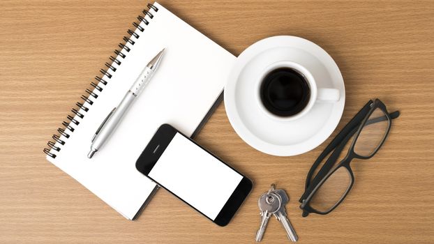 coffee,phone,notepad,eyeglasses and key on wood table background