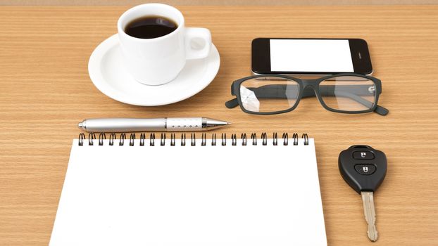 coffee,phone,notepad,eyeglasses and car key on wood table background