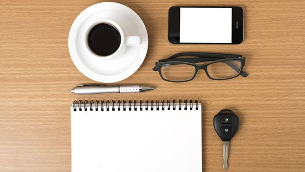 coffee,phone,notepad,eyeglasses and car key on wood table background