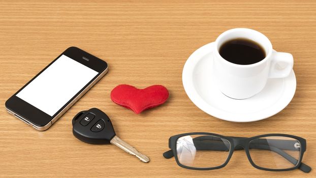 coffee,phone,eyeglasses and car key on wood table background