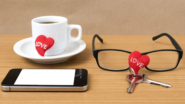 coffee,phone,eyeglasses and key on wood table background