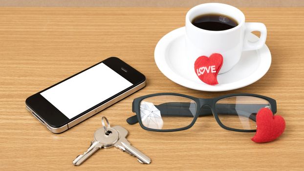 coffee,phone,eyeglasses and key on wood table background