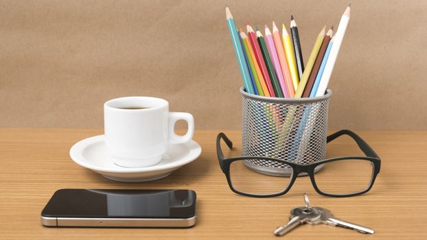 coffee,phone,eyeglasses,color pencil and key on wood table background