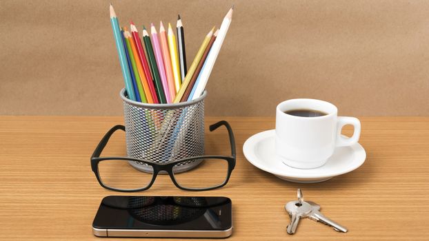 coffee,phone,eyeglasses,color pencil and key on wood table background