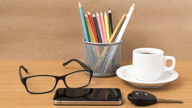 coffee,phone,eyeglasses,color pencil and car key on wood table background