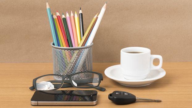 coffee,phone,eyeglasses,color pencil and car key on wood table background