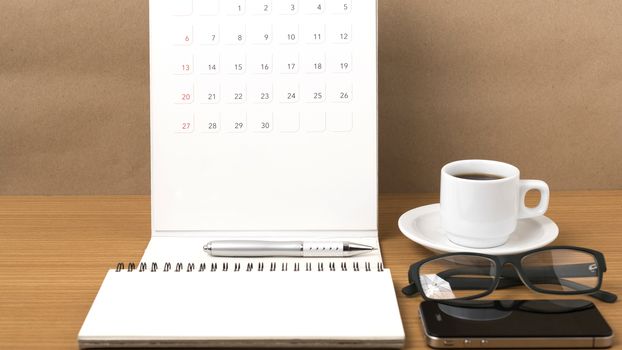 coffee,phone,eyeglasses,notepad and canlendar on wood table background