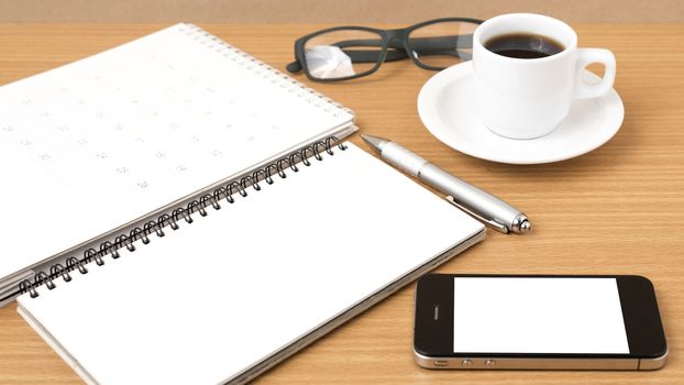 coffee,phone,eyeglasses,notepad and canlendar on wood table background