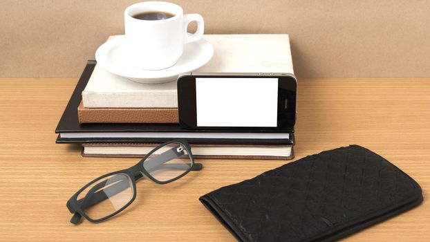 coffee,phone,eyeglasses,stack of book and wallet on wood table background