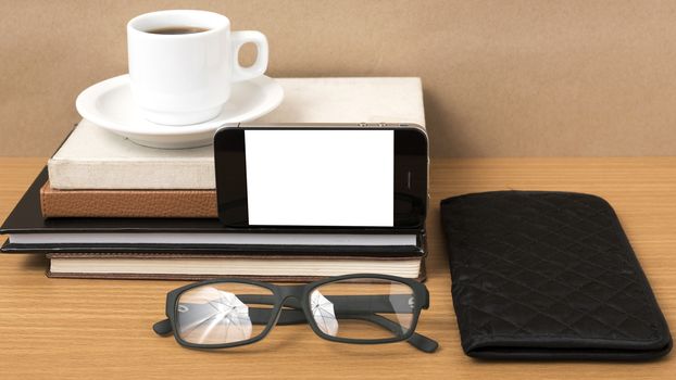 coffee,phone,eyeglasses,stack of book and wallet on wood table background