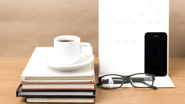 coffee,phone,eyeglasses,stack of book and calendar on wood table background