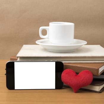 coffee,phone,stack of book and heart on wood table background