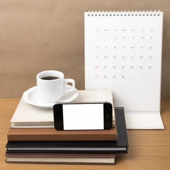 coffee,phone,stack of book and calendar on wood table background