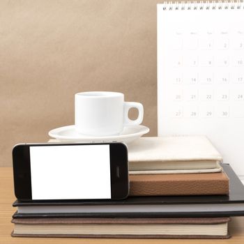 coffee,phone,stack of book and calendar on wood table background