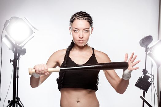 girl with baseball bat in a studio