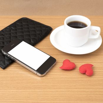 coffee,phone,wallet and heart on wood table background