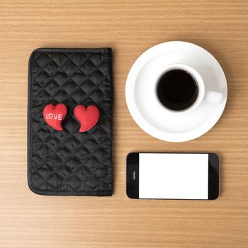 coffee,phone,wallet and heart on wood table background