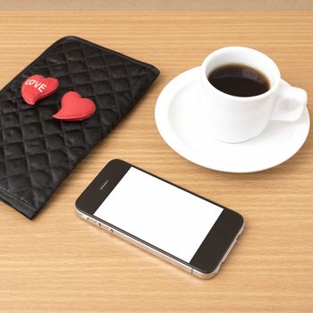 coffee,phone,wallet and heart on wood table background