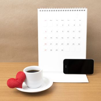 coffee,phone,calendar and heart on wood table background