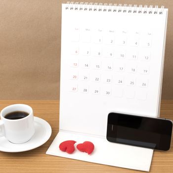 coffee,phone,calendar and heart on wood table background