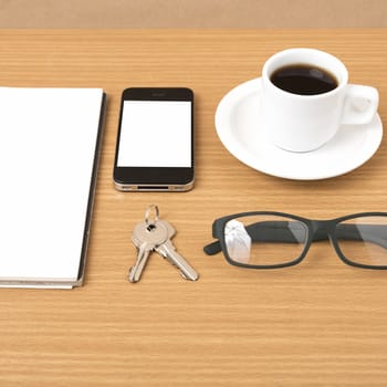 coffee,phone,notepad,eyeglasses and key on wood table background