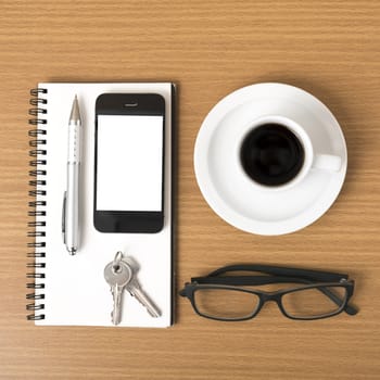 coffee,phone,notepad,eyeglasses and key on wood table background