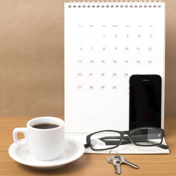 coffee,phone,eyeglasses,calendar and key on wood table background