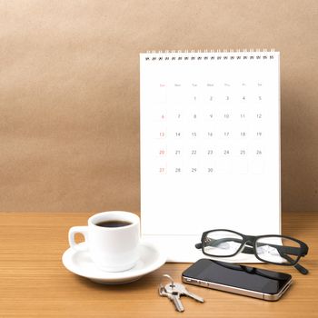 coffee,phone,eyeglasses,calendar and key on wood table background