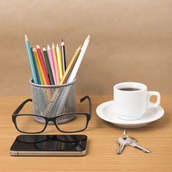 coffee,phone,eyeglasses,color pencil and key on wood table background