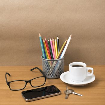 coffee,phone,eyeglasses,color pencil and key on wood table background