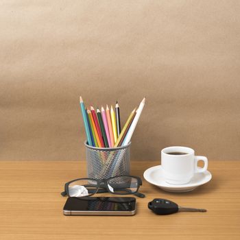 coffee,phone,eyeglasses,color pencil and car key on wood table background