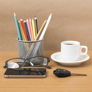 coffee,phone,eyeglasses,color pencil and car key on wood table background